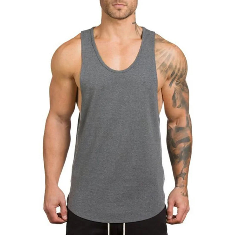 Men’s Gym Vest Bodybuilding Tank Top Fitness Stringer Workout Wear in gray worn by a muscular man.