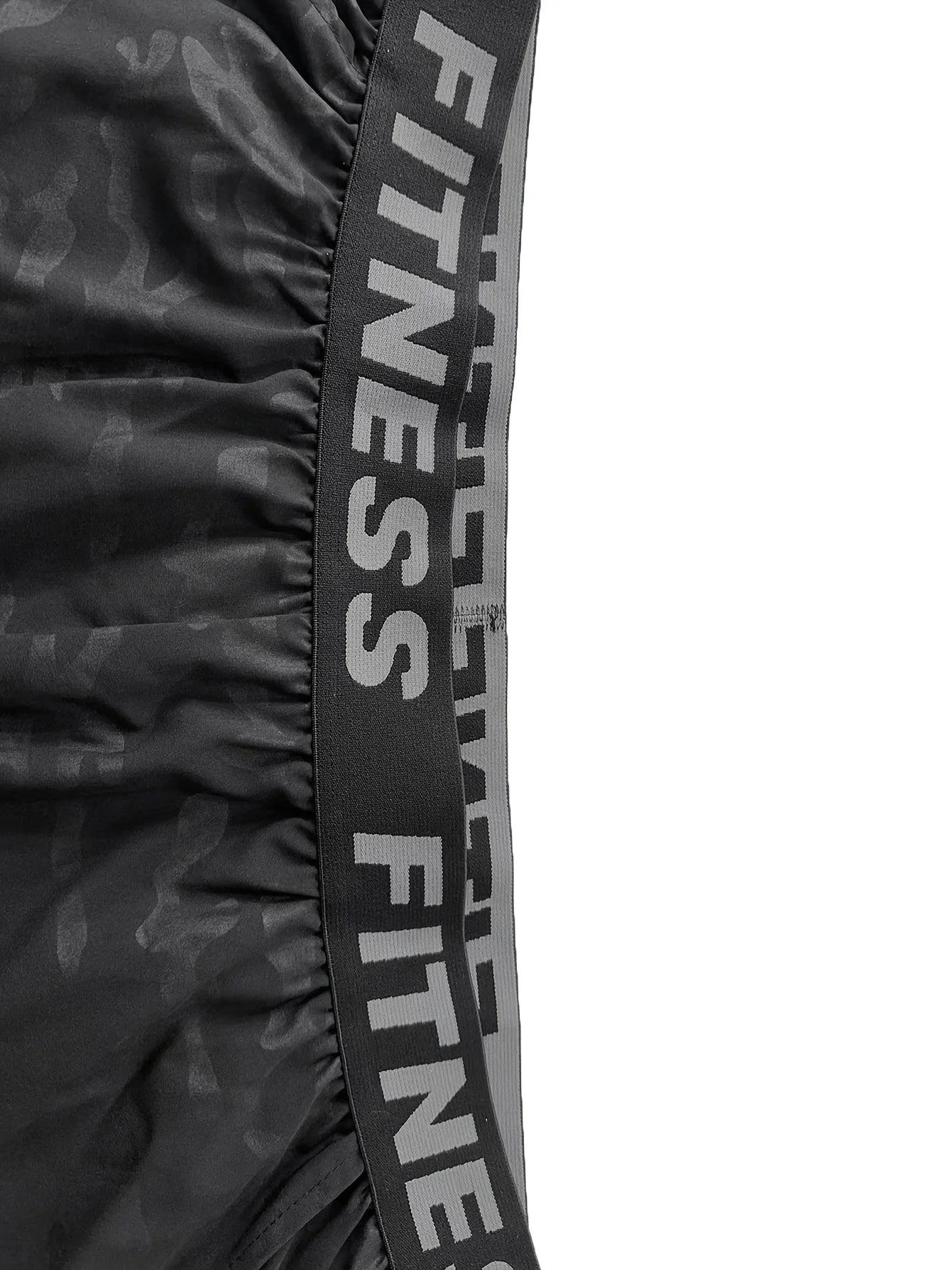 Close-up of the waistband of Men's Bull Print Sports Shorts 3-Piece Set featuring a bold 'FITNESS' print.