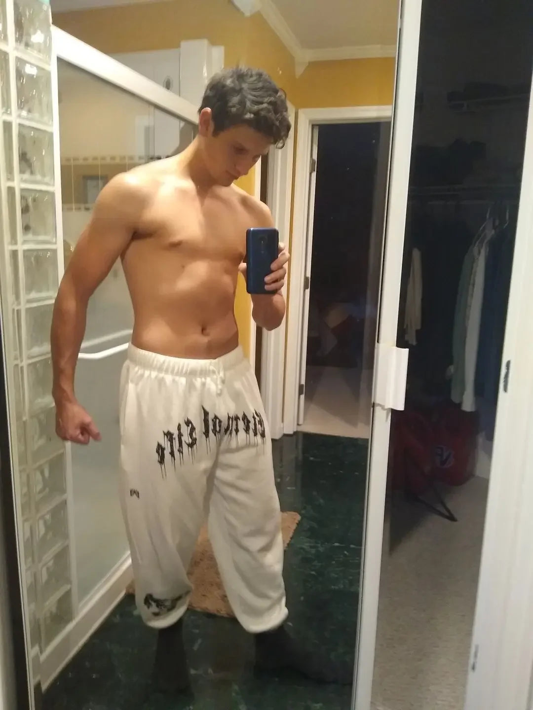 2024 Men’s Sports Pants Casual Gym Training Joggers for New Year worn by a male in a mirror selfie.