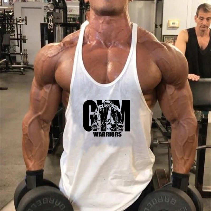 Men’s Gym Tank Top Cotton Y-Back Fitness Muscle Bodybuilding Vest worn by a muscular athlete lifting dumbbells in a gym.