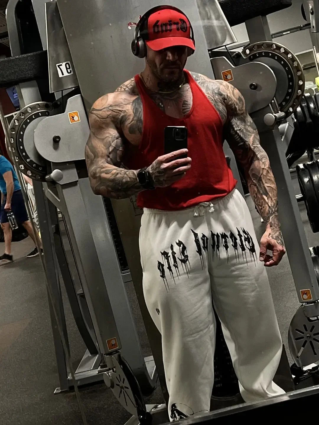 2024 Men’s Sports Pants Casual Gym Training Joggers for New Year worn by a muscular man in gym setting.